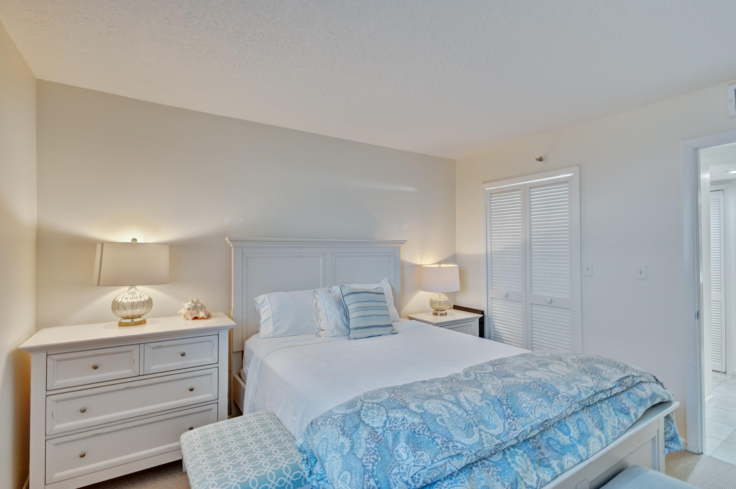 600 Ocean Drive, Unit 11A Juno Beach, FL 33408 - Photo 31 of 51 a bedroom with a bed and cabinet