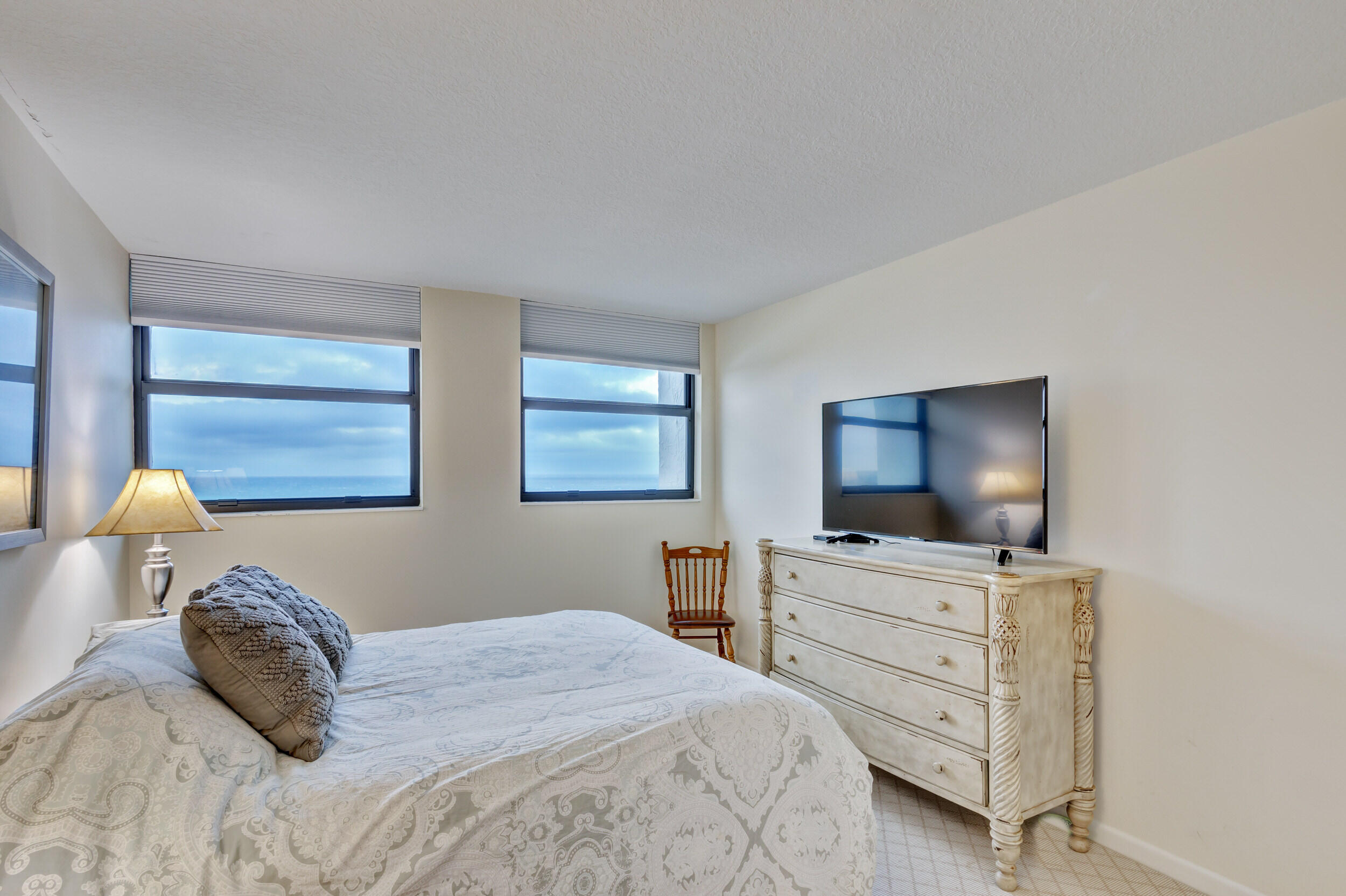 600 Ocean Drive, Unit 11A Juno Beach, FL 33408 - Photo 35 of 51 a bedroom with a bed and a flat screen tv