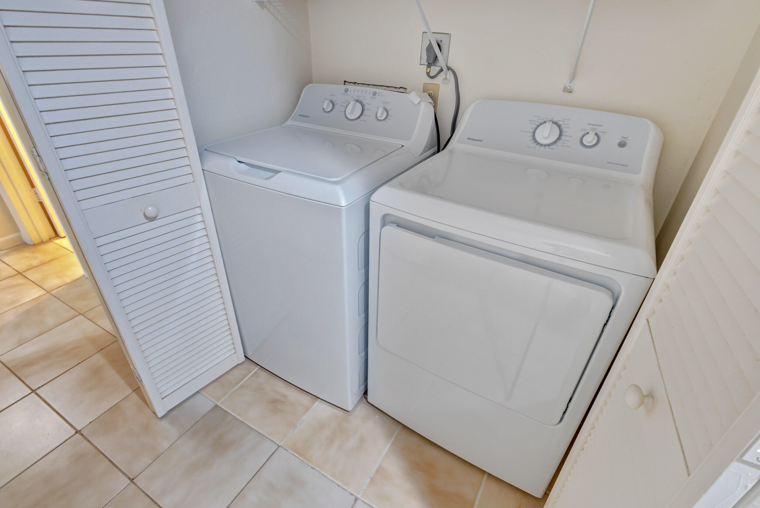600 Ocean Drive, Unit 11A Juno Beach, FL 33408 - Photo 37 of 51 a utility room with dryer and washer