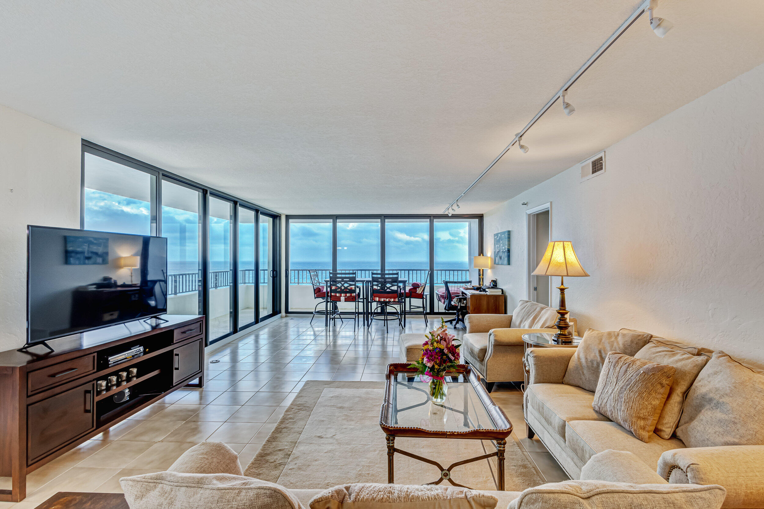 600 Ocean Drive, Unit 11A Juno Beach, FL 33408 - Photo 6 of 51 a living room with furniture and a flat screen tv