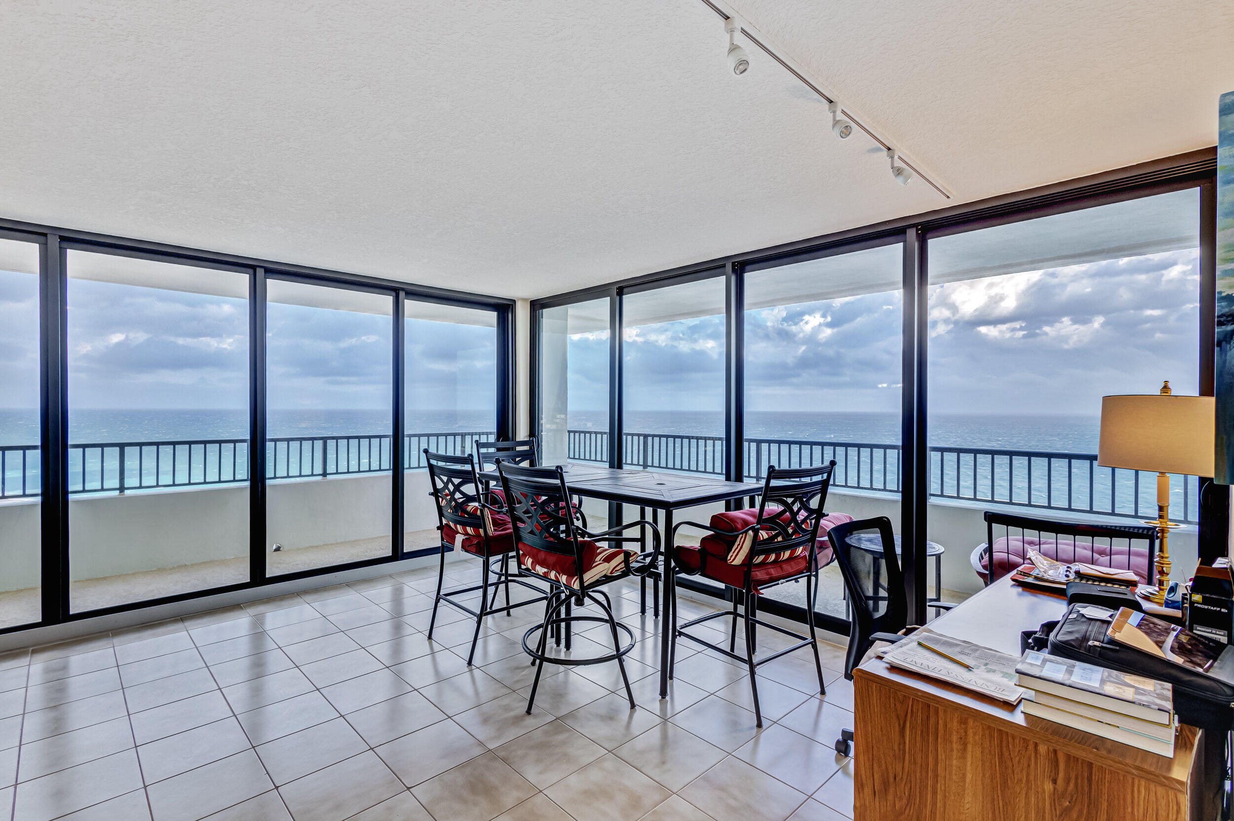 600 Ocean Drive, Unit 11A Juno Beach, FL 33408 - Photo 8 of 51 a view of a city from a dining room with furniture and floor to ceiling windows