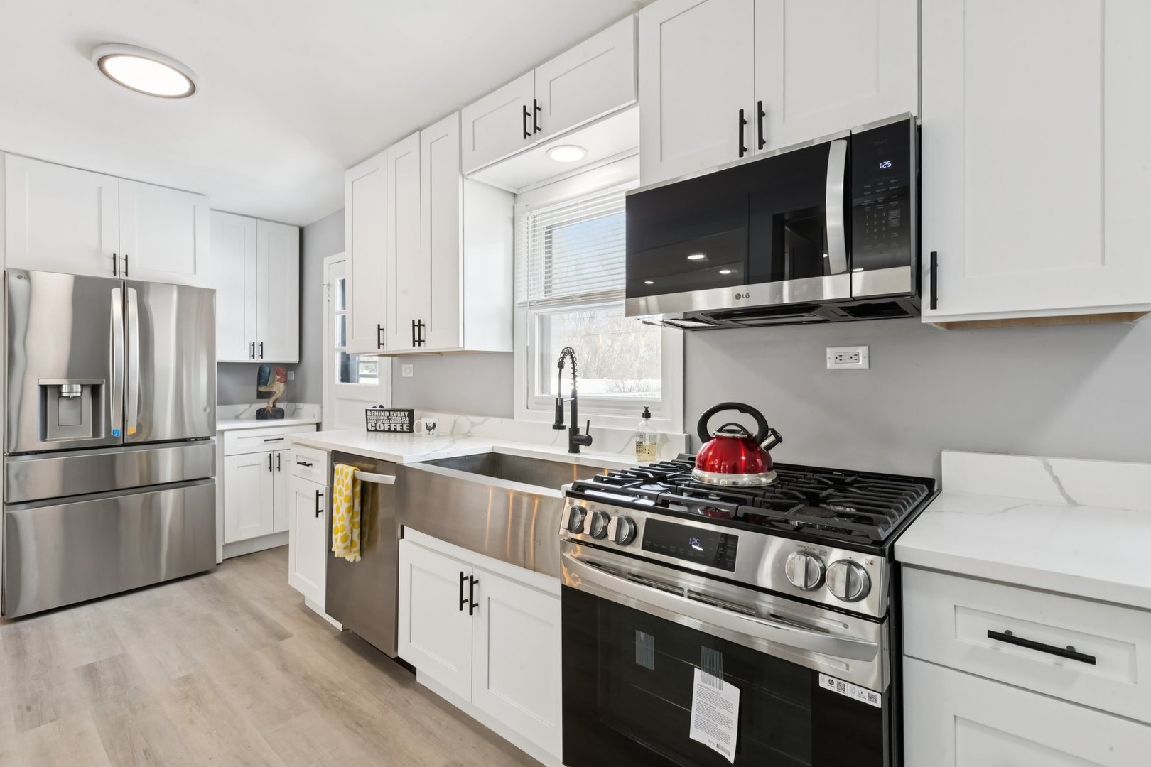 4N327 7th Avenue Addison, IL 60101 - Photo 14 of 49 a kitchen with stainless steel appliances granite countertop a stove a microwave and a refrigerator