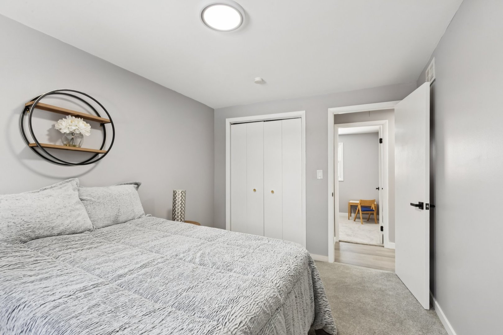 4N327 7th Avenue Addison, IL 60101 - Photo 30 of 49 a bedroom with a large bed and a chandelier