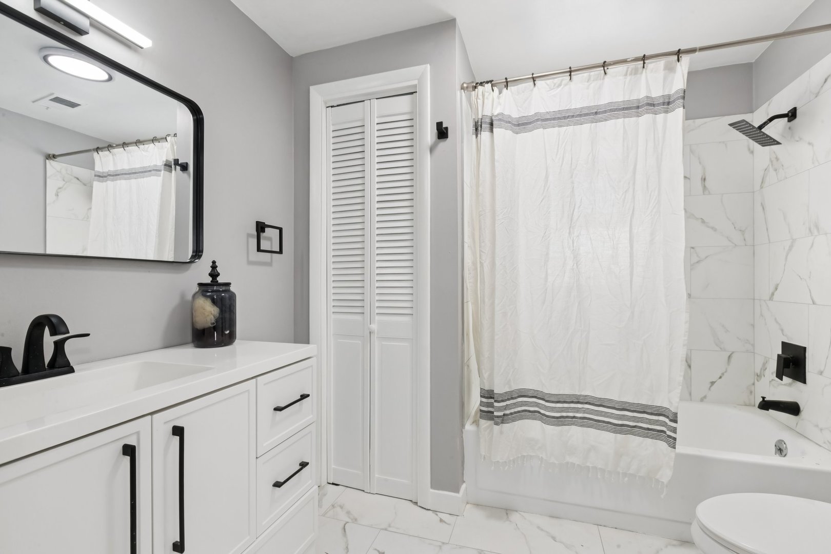 4N327 7th Avenue Addison, IL 60101 - Photo 33 of 49 a bathroom with a sink a toilet and shower