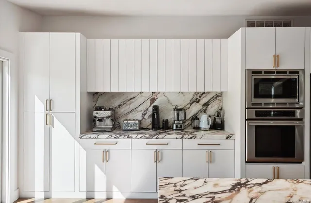 a spacious bedroom with a bed and a flat screen tv