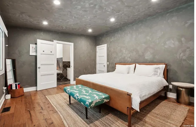 a bedroom with a bed and a large window