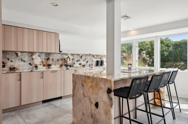 a bedroom with a large bed and a large window