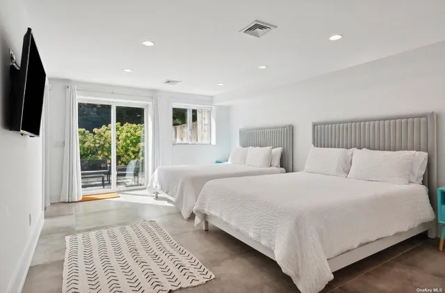 a large bedroom with a bed and a couch