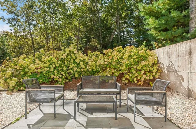 a view of balcony with couch and chairs