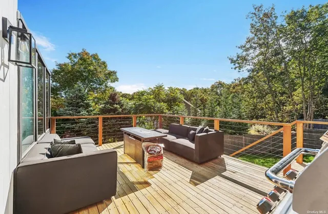 a view of a patio with table and chairs with wooden floor and fence