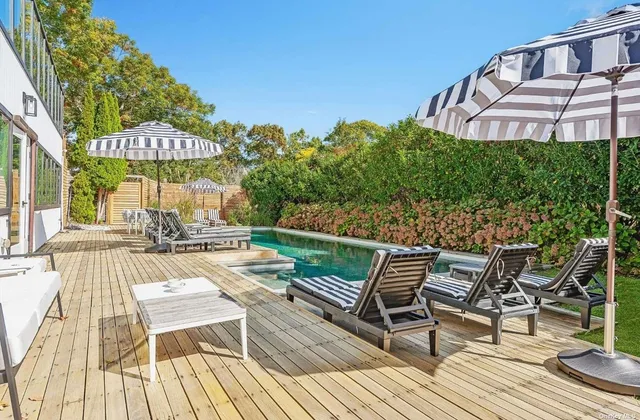 a view of a patio with a table and chairs