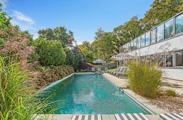 a view of a chair and table in backyard of the house