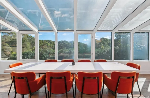 a view of a kitchen with kitchen island a large window appliances and cabinets