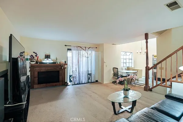 a living room with furniture and stairs