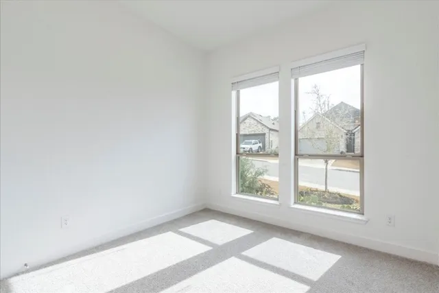 a view of an empty room and a window