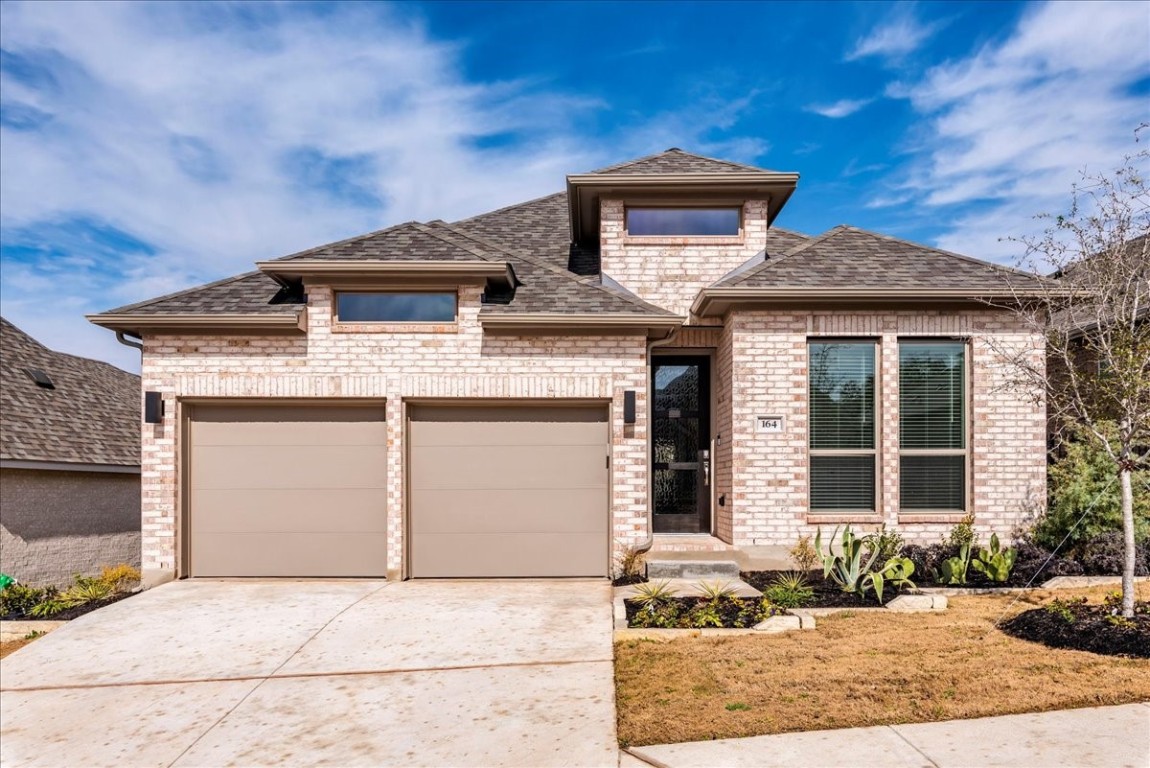 164 Kimble Creek Loop Kyle, TX 78640 - Photo 2 of 35 a front view of a house with a yard