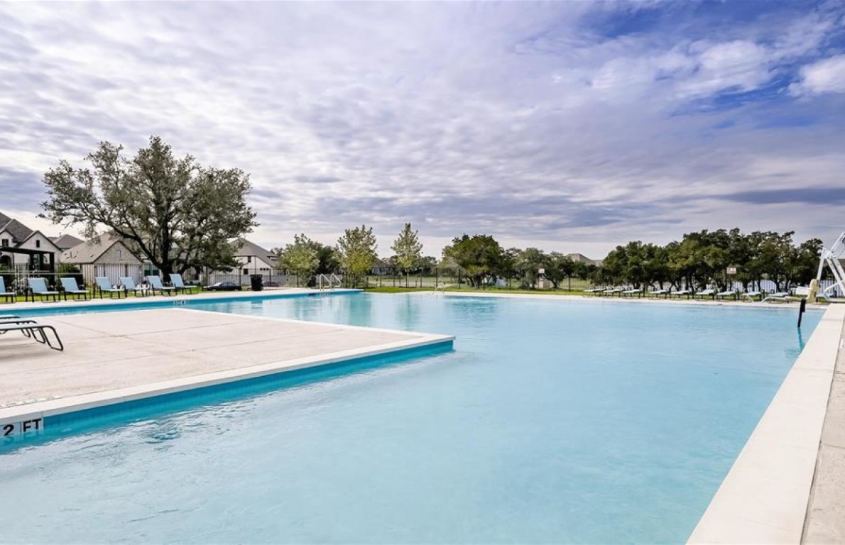 164 Kimble Creek Loop Kyle, TX 78640 - Photo 31 of 35 a view of a lake with houses in the back