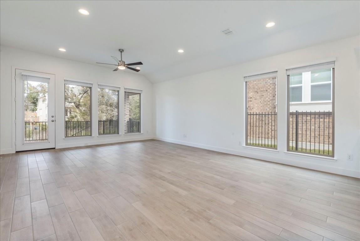 164 Kimble Creek Loop Kyle, TX 78640 - Photo 9 of 35 a view of an empty room with a window and wooden floor