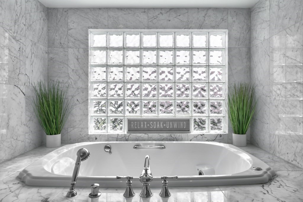 175 Rice Avenue Revere, MA 02151 - Photo 19 of 30 a bath tub sitting in a bathroom next to a window