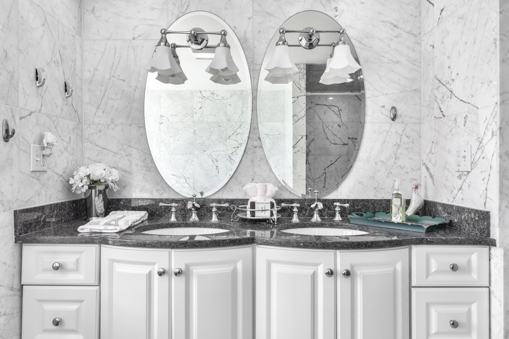 175 Rice Avenue Revere, MA 02151 - Photo 20 of 30 a bathroom with double vanity sinks granite vanity and a mirror