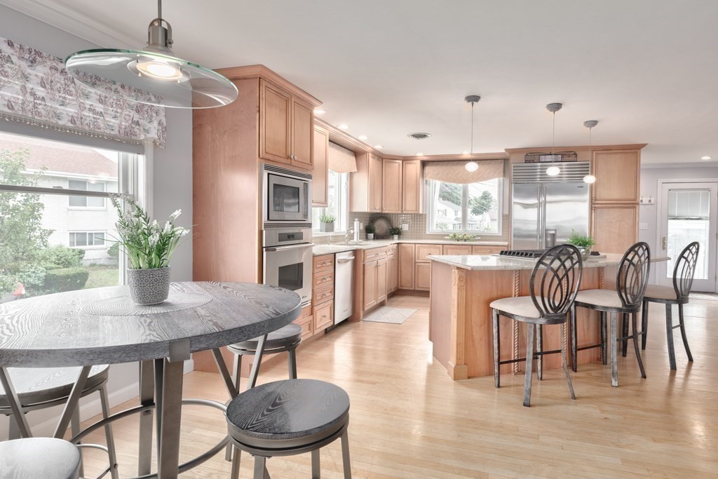 175 Rice Avenue Revere, MA 02151 - Photo 9 of 30 a kitchen with kitchen island a dining table and chairs