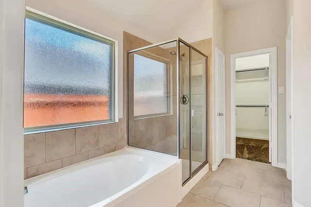 a bathroom with a sink double vanity granite tub and shower