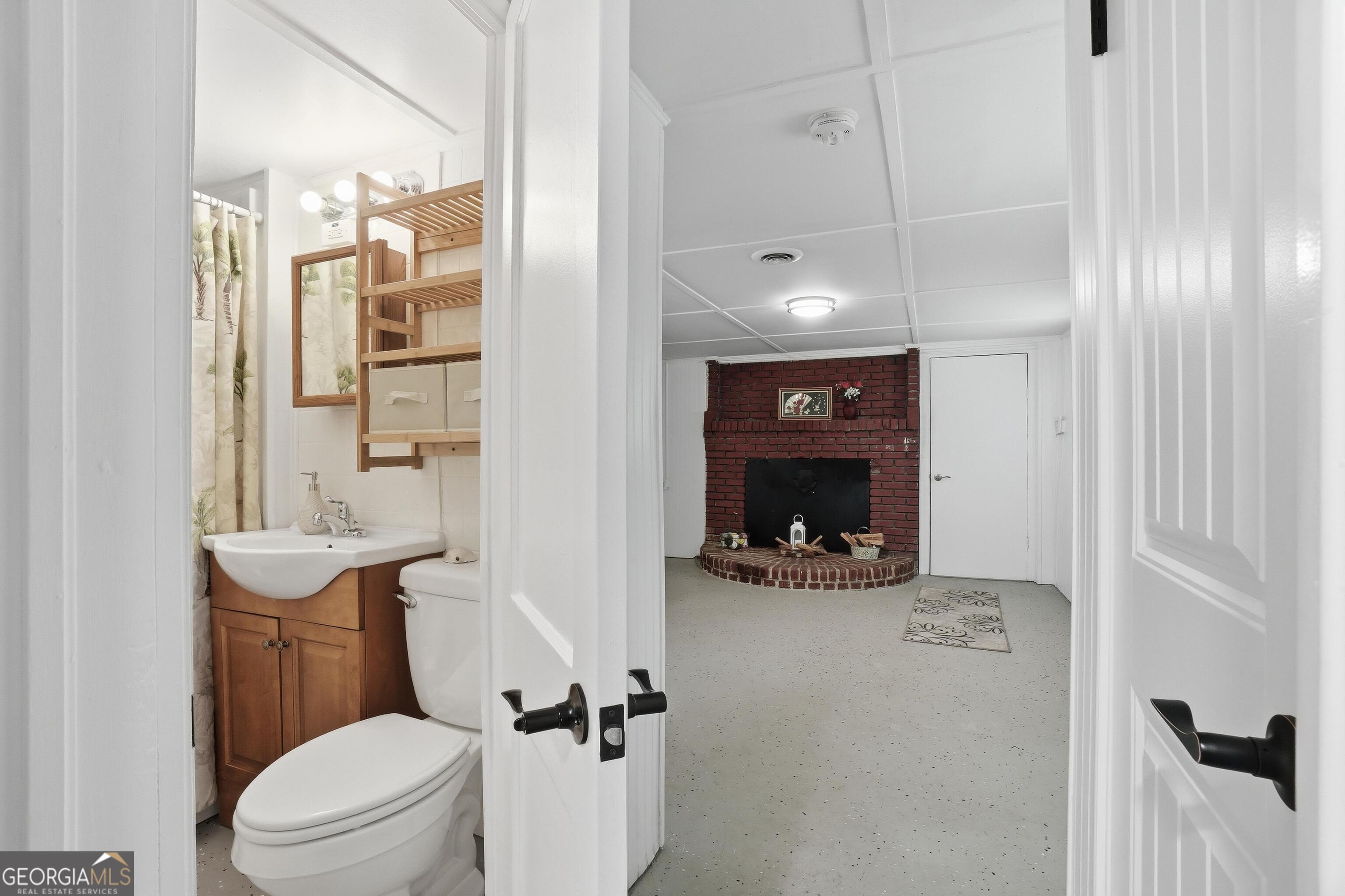 3022 Maple Road Southeast Lindale, GA 30147 - Photo 21 of 29 a bathroom with a sink a toilet and shower