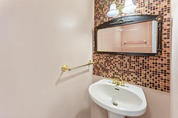 a bathroom with a sink and mirror