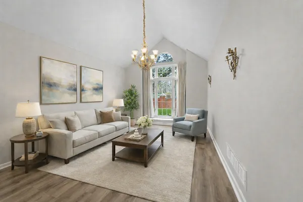 a living room with furniture and a chandelier