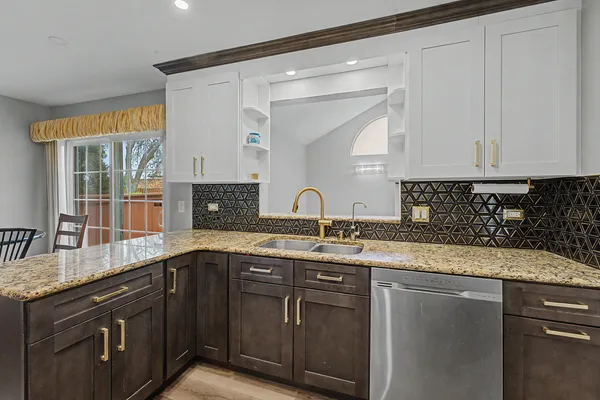 a kitchen with stainless steel appliances granite countertop a sink stove and cabinets