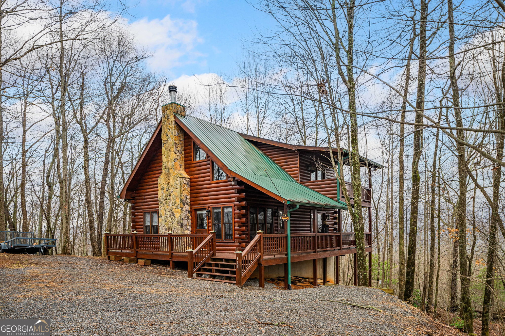 a view of a house with a yard and wooden fence