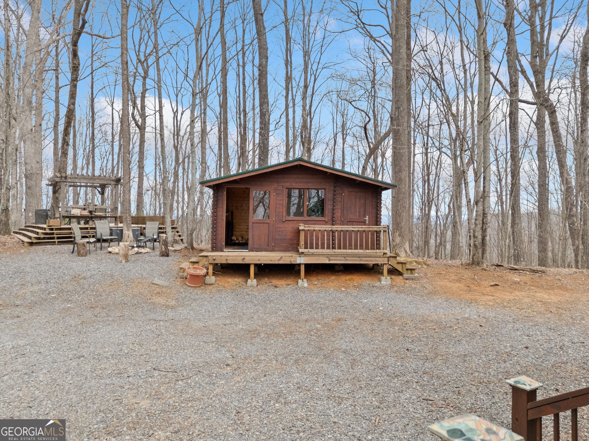 541 Little Bushy Head Road, Unit 271 Blue Ridge, GA 30513 - Photo 39 of 43 a backyard of a house with barbeque oven and trees