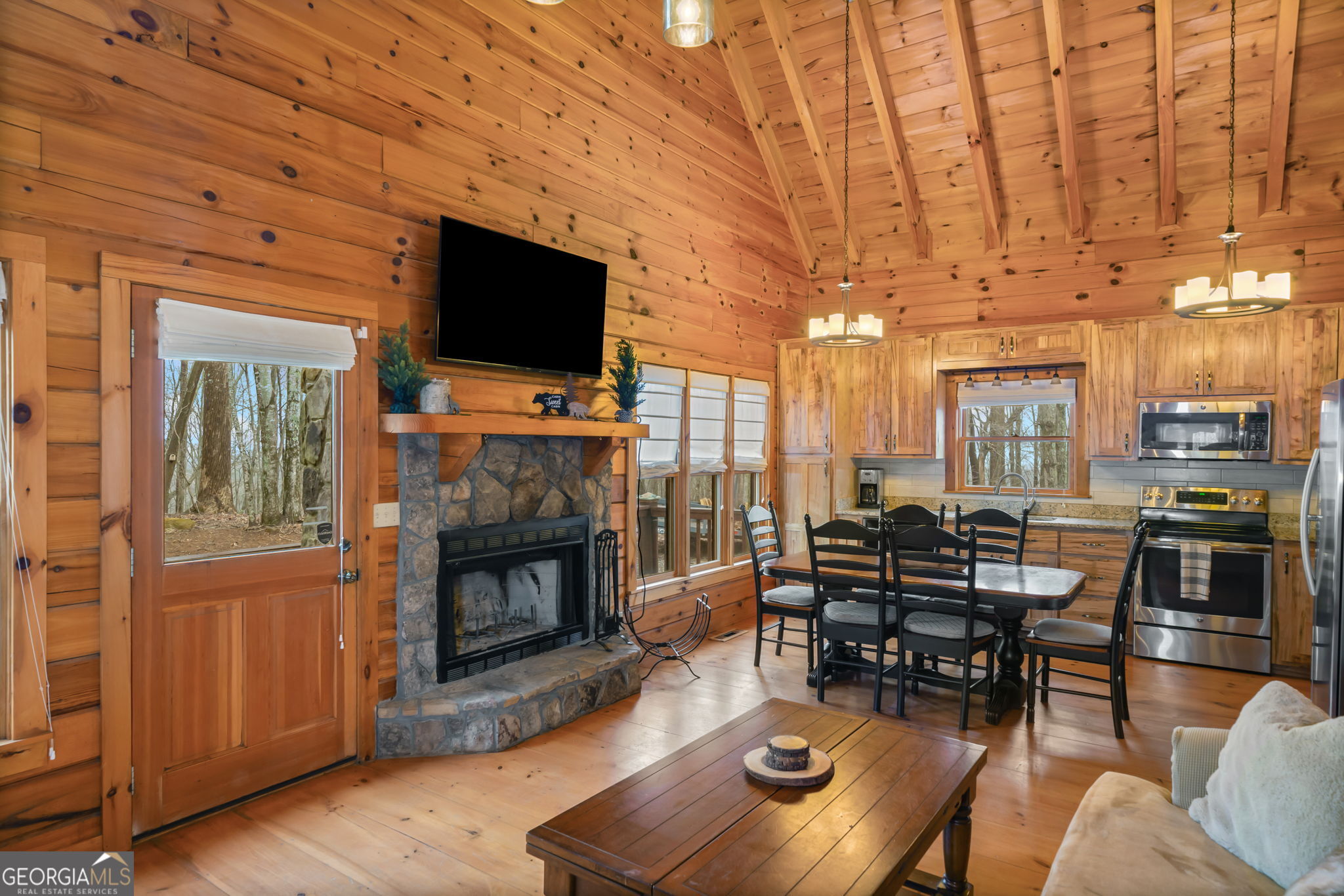 541 Little Bushy Head Road, Unit 271 Blue Ridge, GA 30513 - Photo 7 of 43 a living room with furniture a flat screen tv and a fireplace