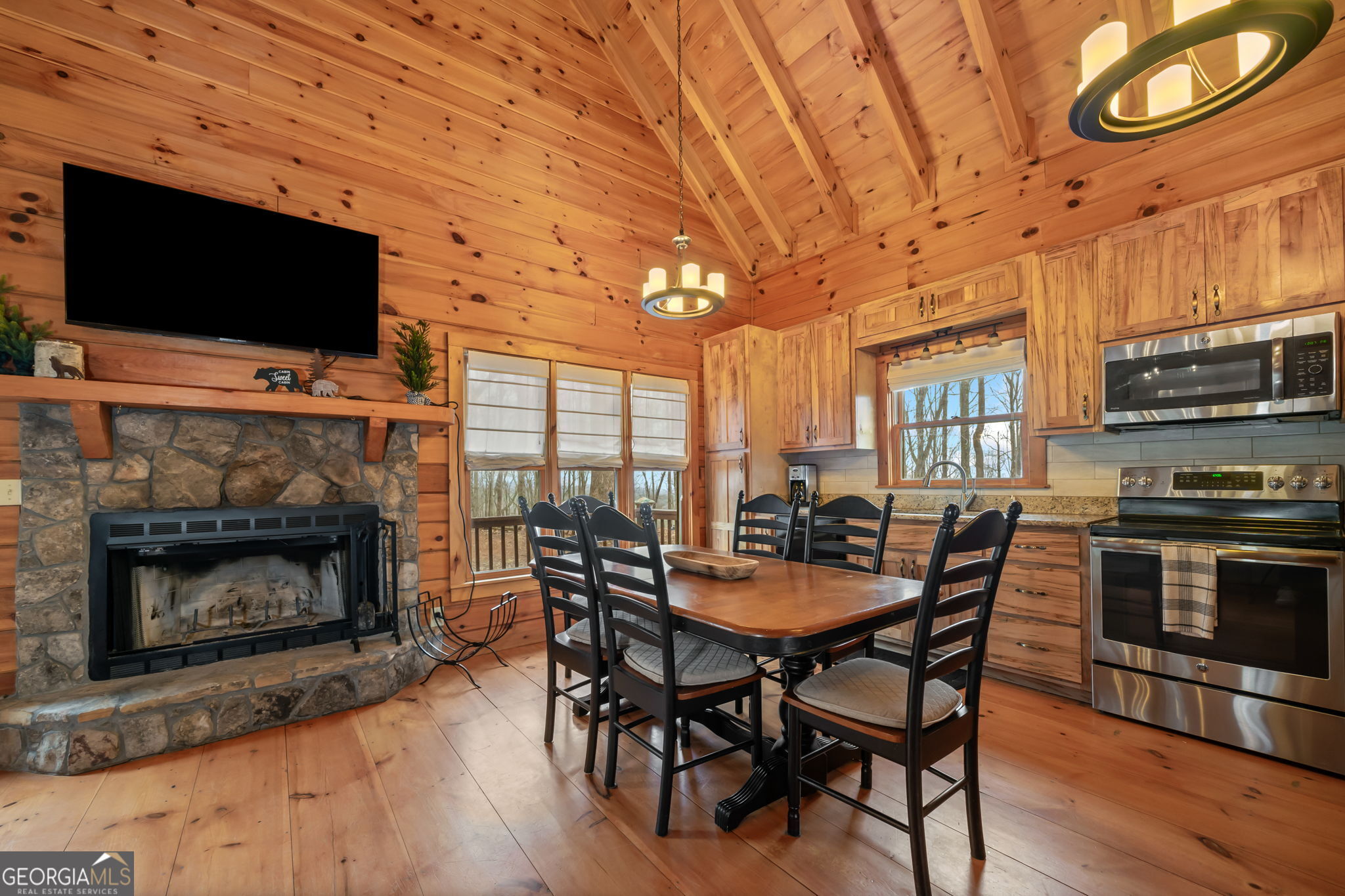 541 Little Bushy Head Road, Unit 271 Blue Ridge, GA 30513 - Photo 9 of 43 a dining room with furniture wooden floor fire place and a fireplace