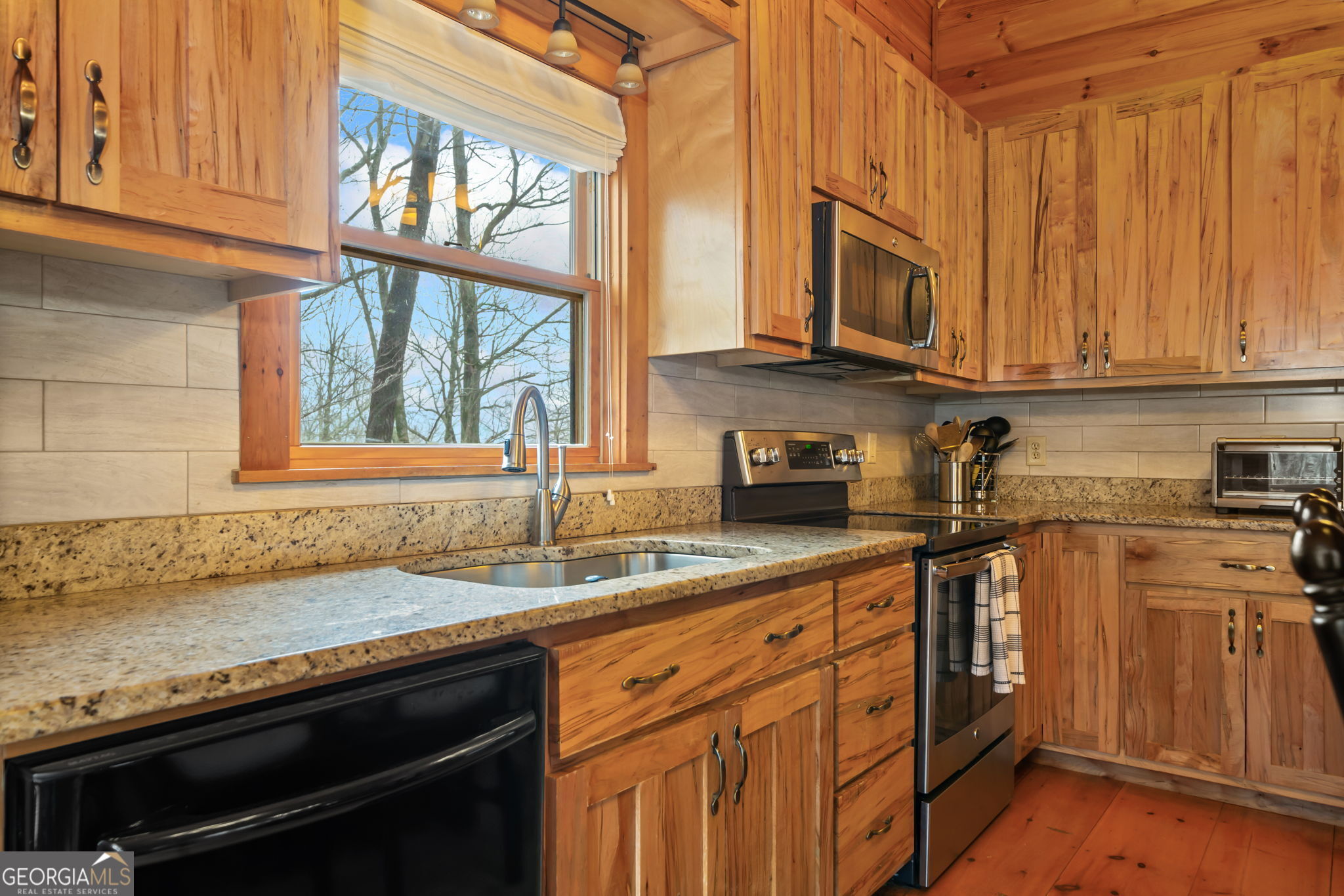 541 Little Bushy Head Road, Unit 271 Blue Ridge, GA 30513 - Photo 10 of 43 a kitchen with stainless steel appliances granite countertop a sink a stove and a microwave
