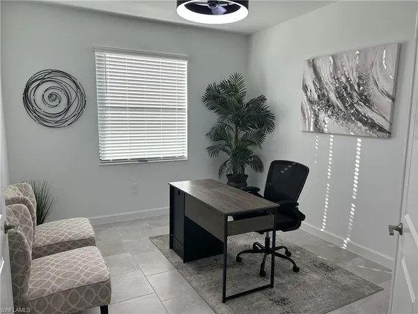 a living room with furniture and a chair