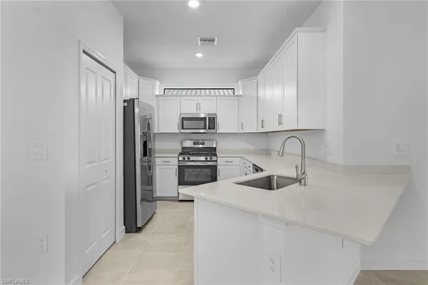 a kitchen with a refrigerator sink and microwave