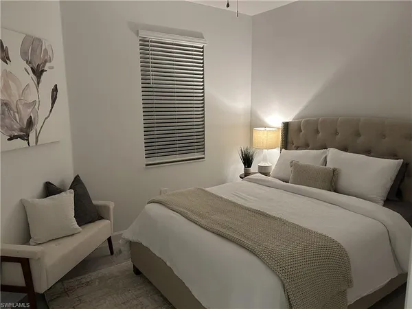 a bedroom with a bed and a couch