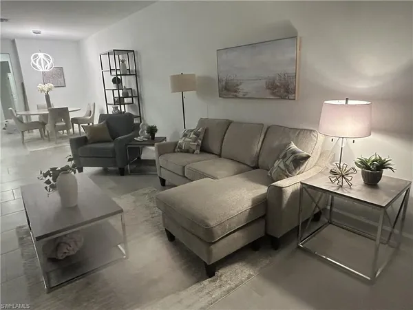 a living room with furniture and a lamp