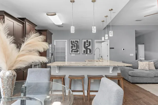 a living room with furniture and kitchen view