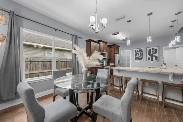 a view of a dining room with furniture window and wooden floor