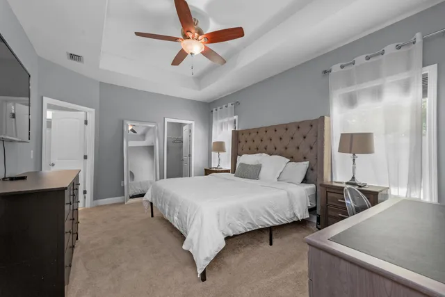 a bedroom with a bed and a chandelier