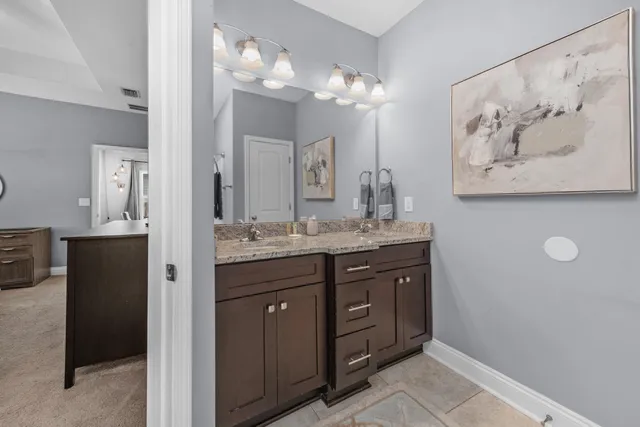 a bathroom with a double vanity sink and a mirror