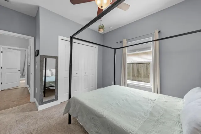 a bedroom with a bed and sliding door