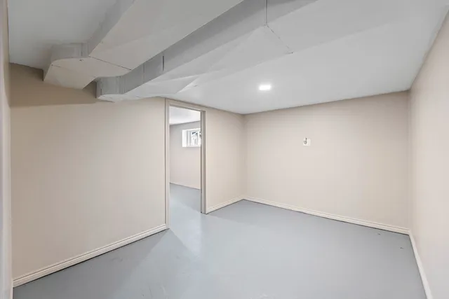 an empty room with a empty space and windows