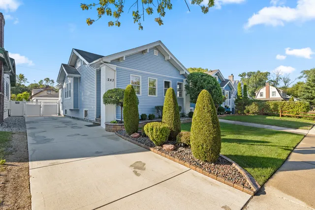 a front view of house with yard and outdoor seating