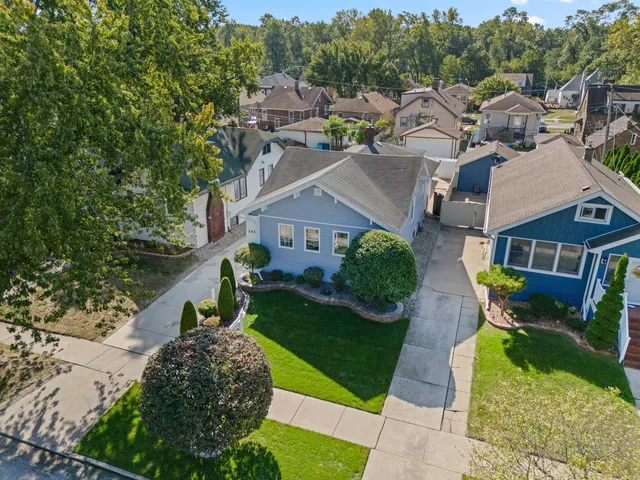 an aerial view of a house with a yard basket ball court and outdoor seating