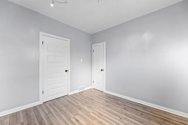 a view of room with wooden floor