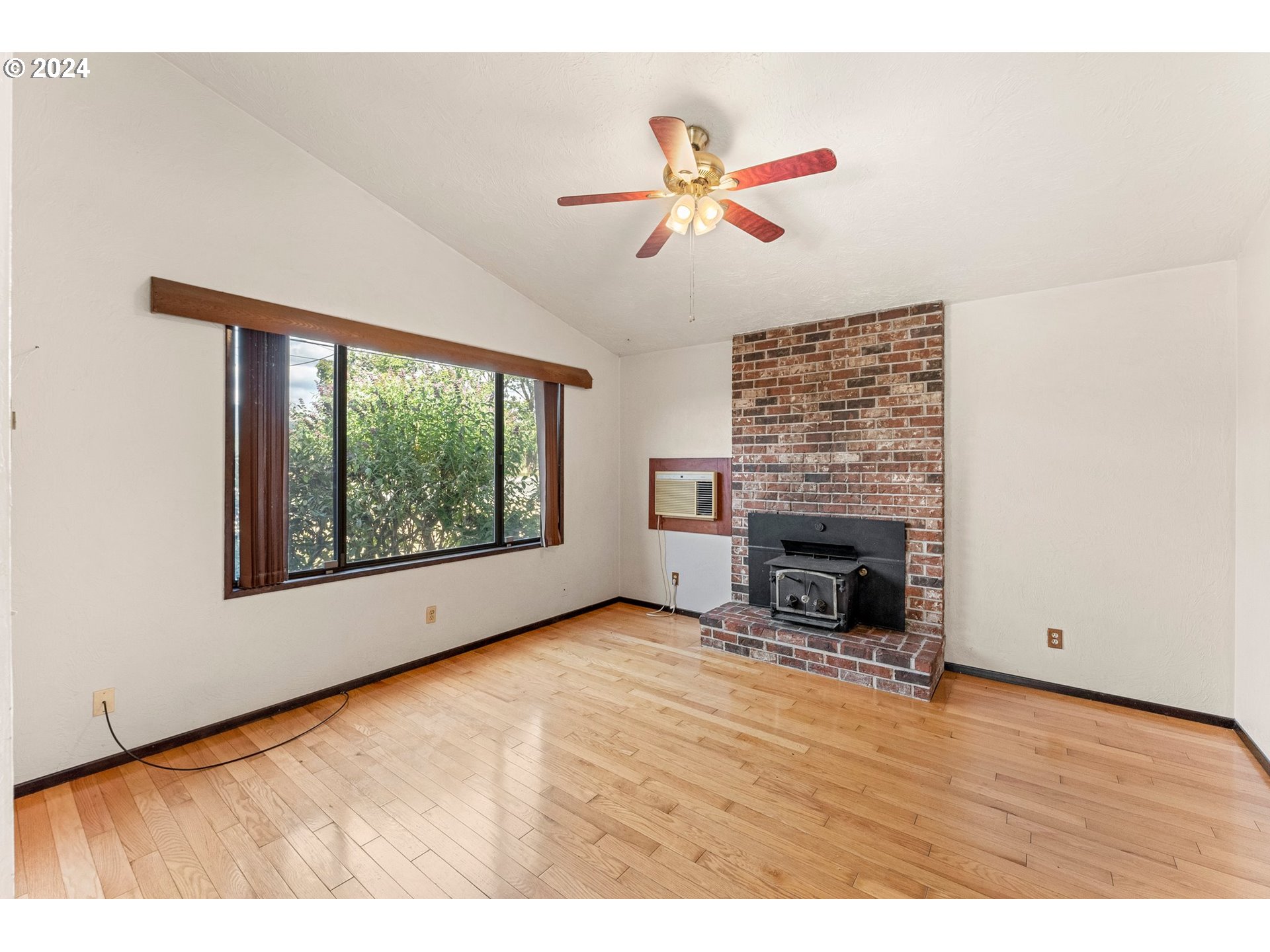 5795 High Banks Road Springfield, OR 97478 - Photo 6 of 41 a view of an empty room with a window and fireplace