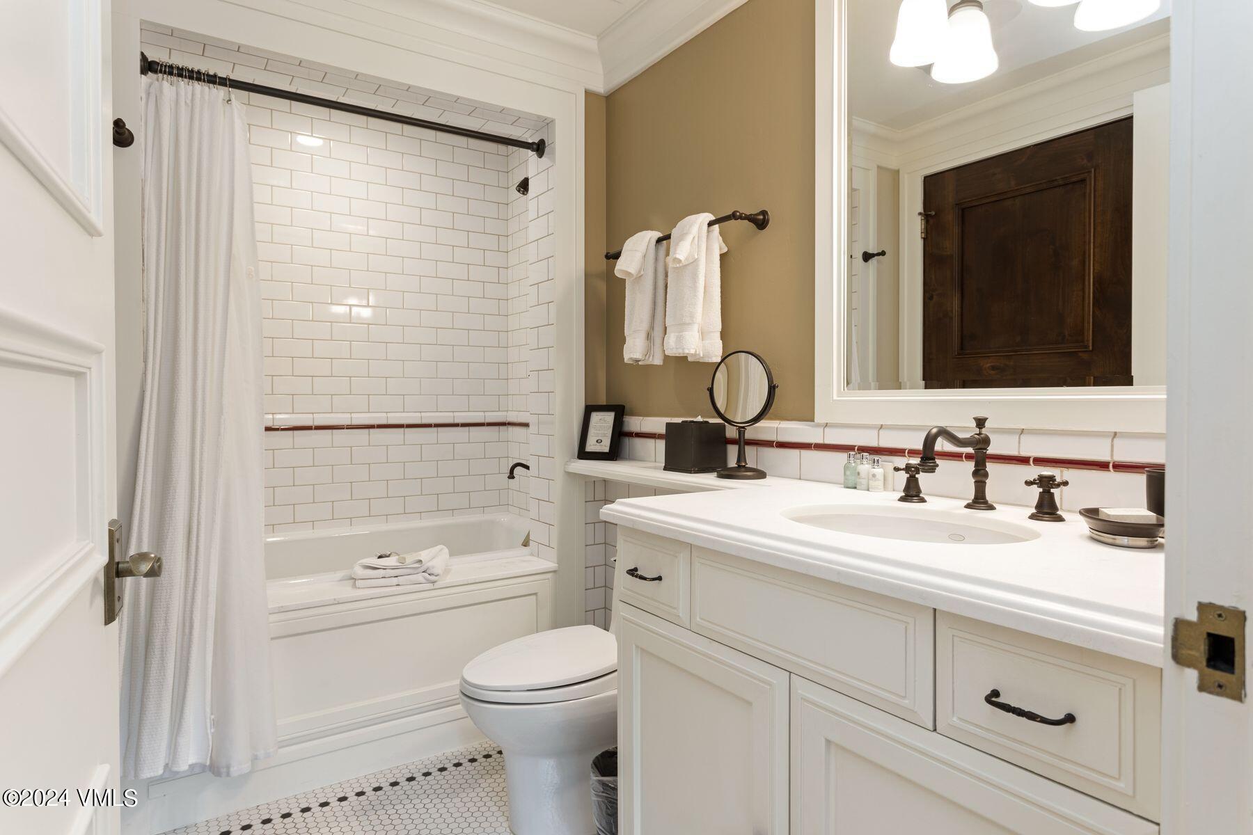 1 Willow Bridge Road, Unit 22D Vail, CO 81657 - Photo 25 of 39 a bathroom with a sink a toilet and a large mirror